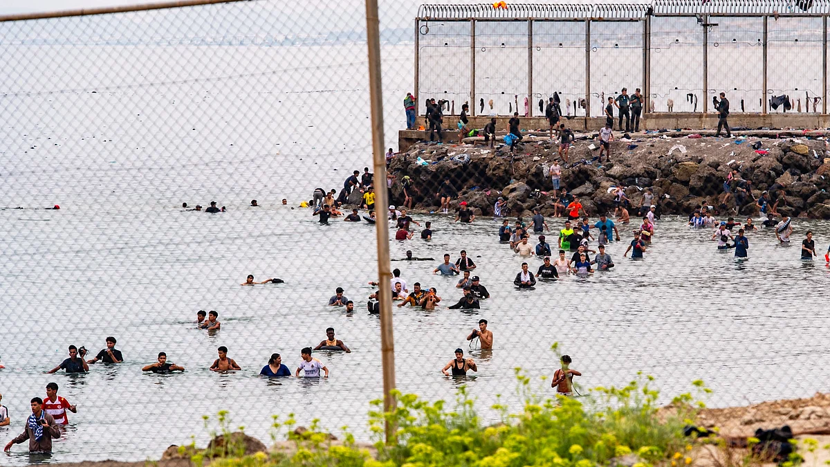 Migrants try to cross from Morocco into the Spanish enclave of Ceuta, 31 July