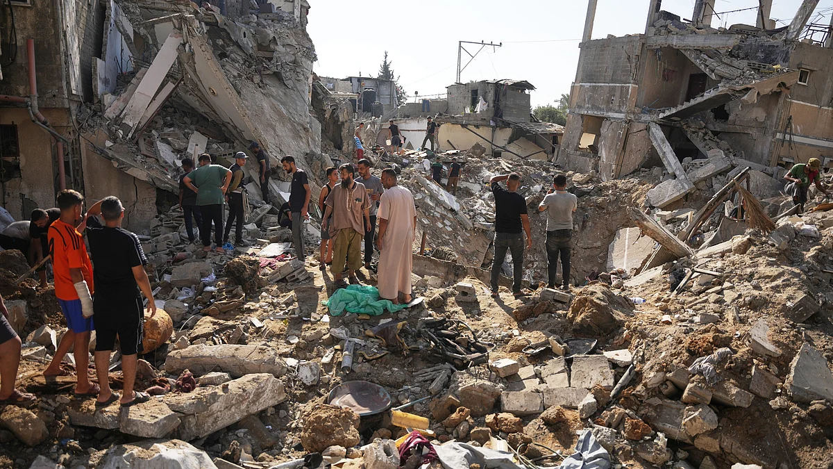 Palestinians inspect damage after an Israeli airstrike at al-Maghazi refugee camp in central Gaza.