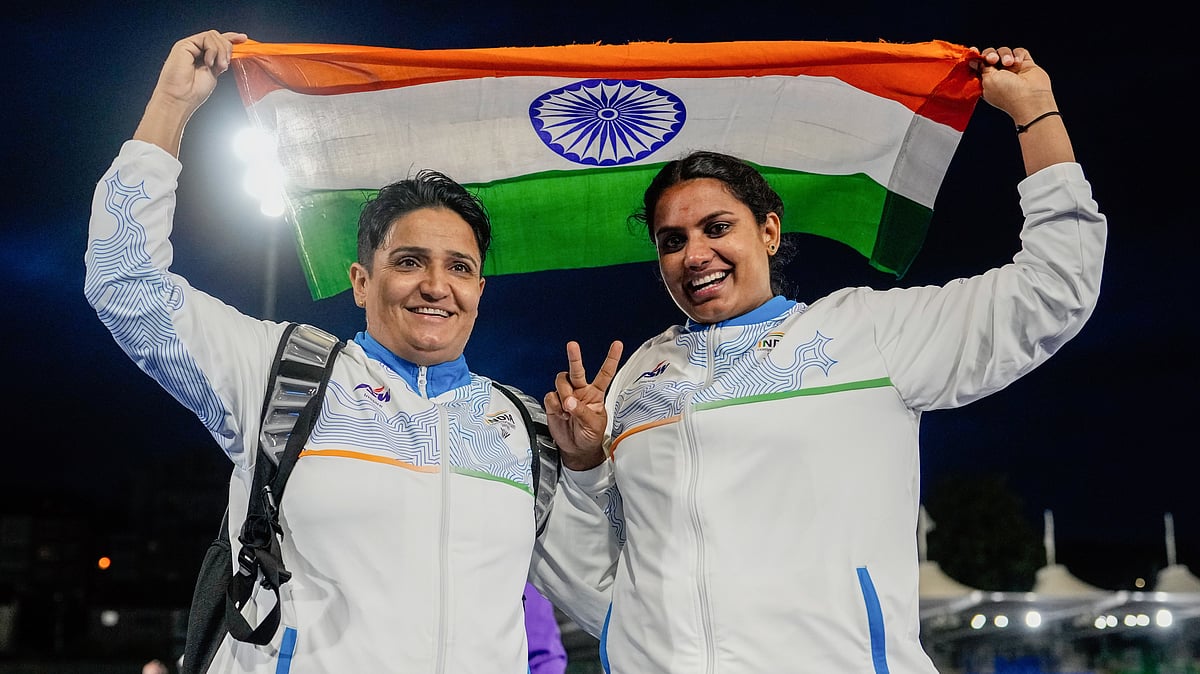 Sharmila Dhankar (L) and Shilpa K. Shyla celebrate after winning gold and bronze in the women's shot put