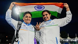 Sharmila Dhankar (L) and Shilpa K. Shyla celebrate after winning gold and bronze in the women's shot put