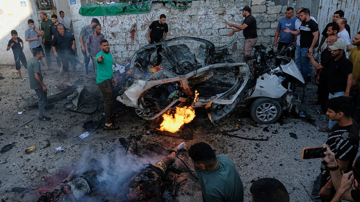 Palestinians respond at the site of an Israeli military strike in Gaza City.