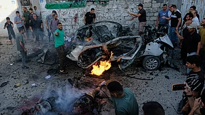 Palestinians respond at the site of an Israeli military strike in Gaza City.