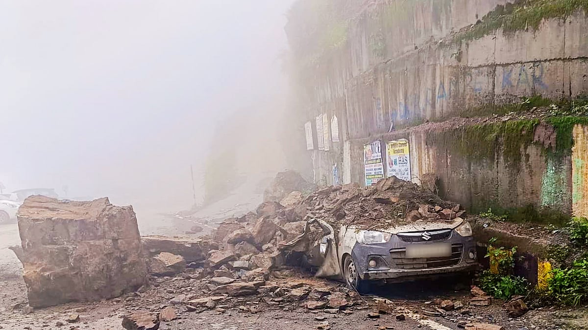 A car crushed under boulders after a landslide amid heavy rains at Theog, Shimla district, 3 Aug