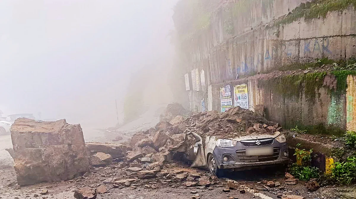 A car crushed under boulders after a landslide amid heavy rains at Theog, Shimla district, 3 Aug