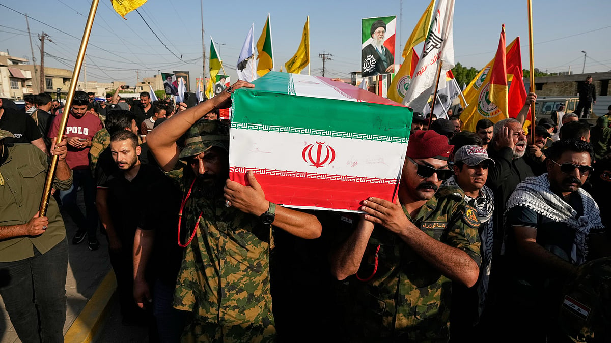Mourners carry the flag-draped coffin of an Iranian adviser during a funeral procession.