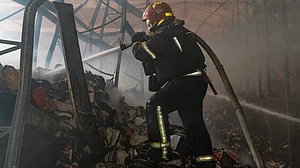 A firefighter battles flames at a major book warehouse in Kharkiv.