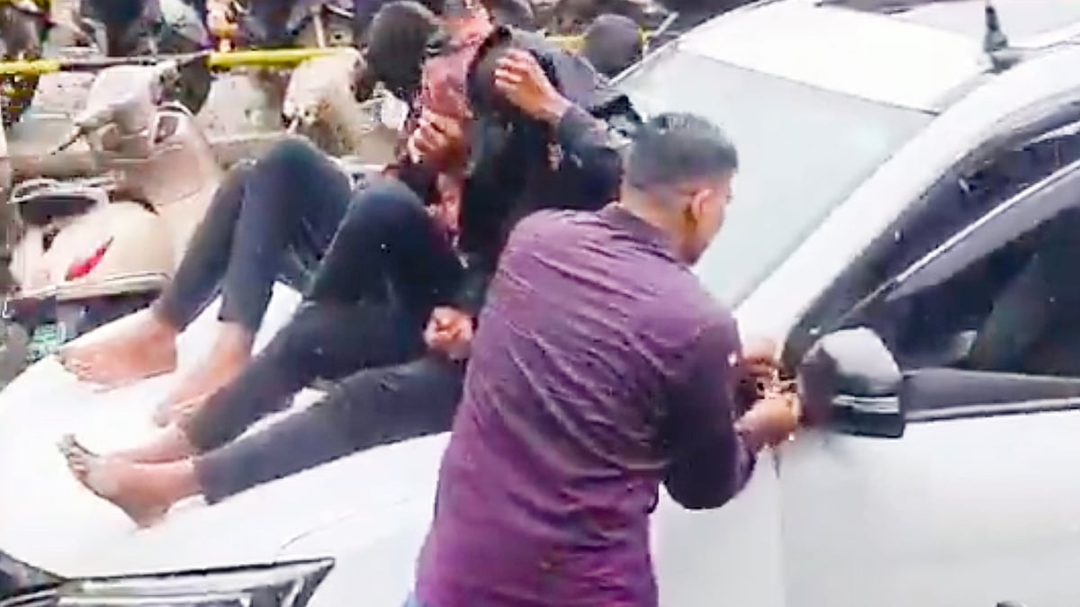 Video screenshot of the three accused on the bonnet