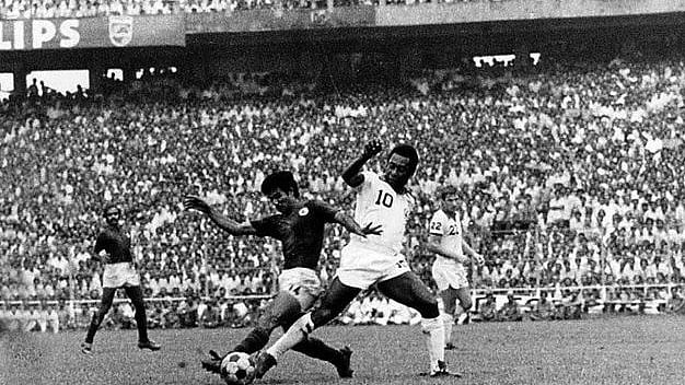 Freeze frame: Pele being challenged by Gautam Sarkar. Pradip Choudhury to the left