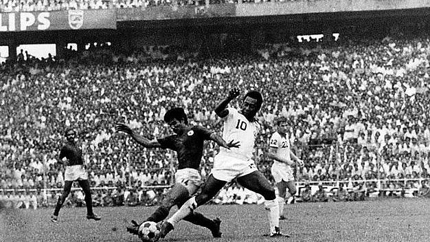 Freeze frame: Pele being challenged by Gautam Sarkar. Pradip Choudhury to the left