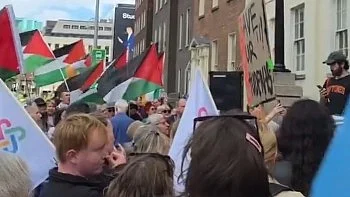 A crowd protesting at the Department of Justice against denied Gaza student visas