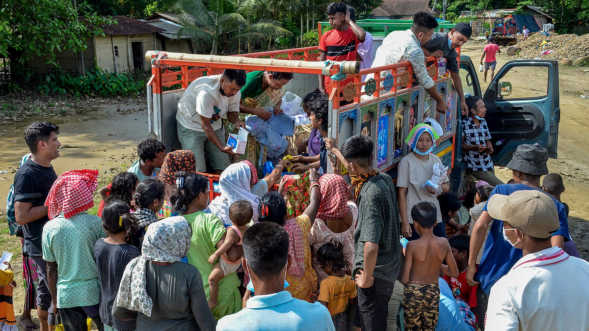 Flood-hit residents in Assam's Sivasagar gather for relief supplies.