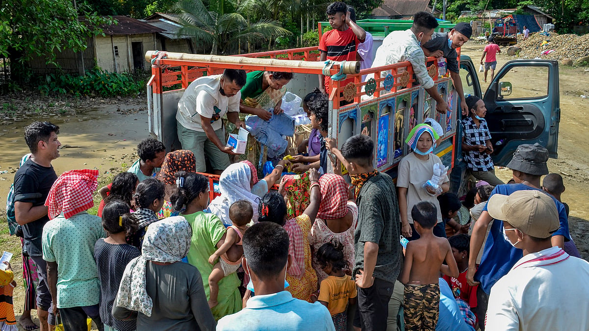 Flood-hit residents in Assam's Sivasagar gather for relief supplies.