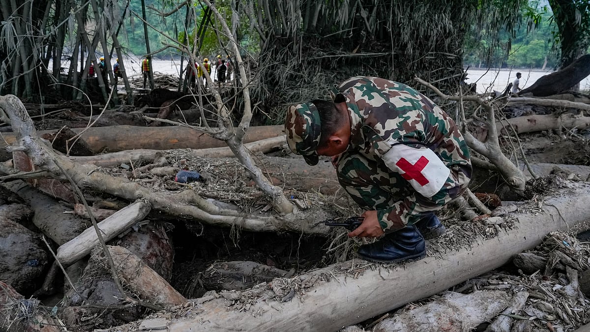 Nepal Army personnel conduct a search operation along a river in Charaudi, Dhading district.