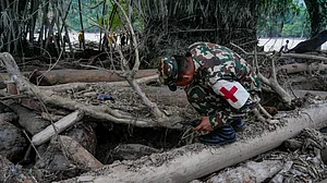 Nepal Army personnel conduct a search operation along a river in Charaudi, Dhading district.