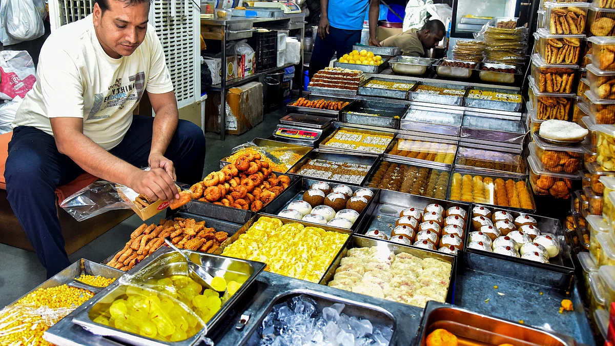 A shopkeeper arranges sweets for sale, in Bikaner, 23 August