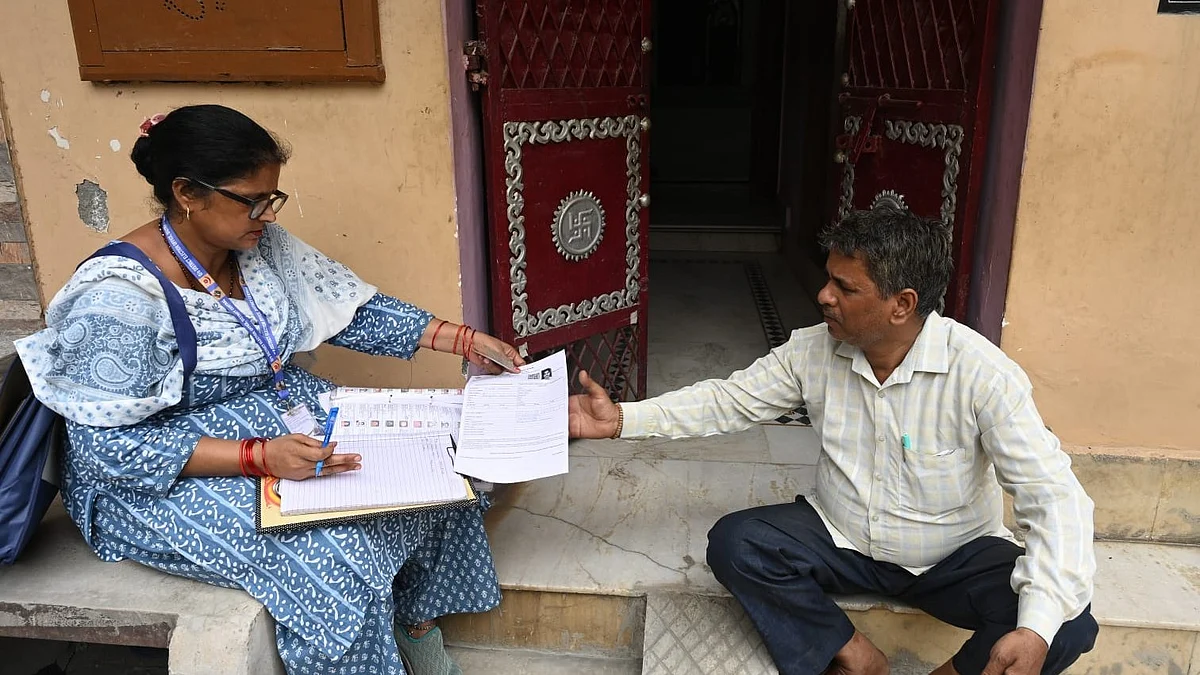 A BLO verifies voter details during a door-to-door drive in New Delhi