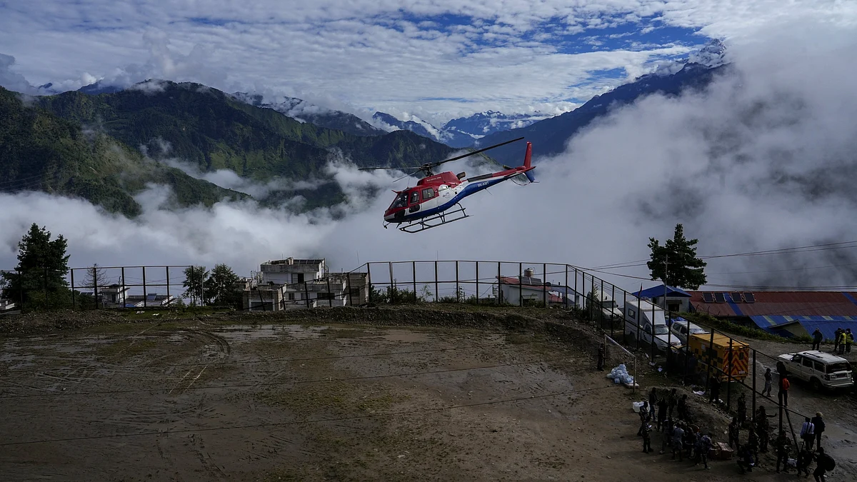 Security personnel conduct search and rescue operations following devastating flash floods in Rasuwa.