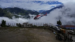 Security personnel conduct search and rescue operations following devastating flash floods in Rasuwa.