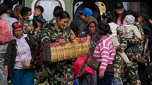 Nepal Army official carries a baby rescued from devastating flash floods in Rasuwa.