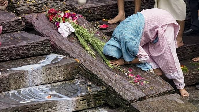 A family member mourns during a symbolic funeral of her loved one. 