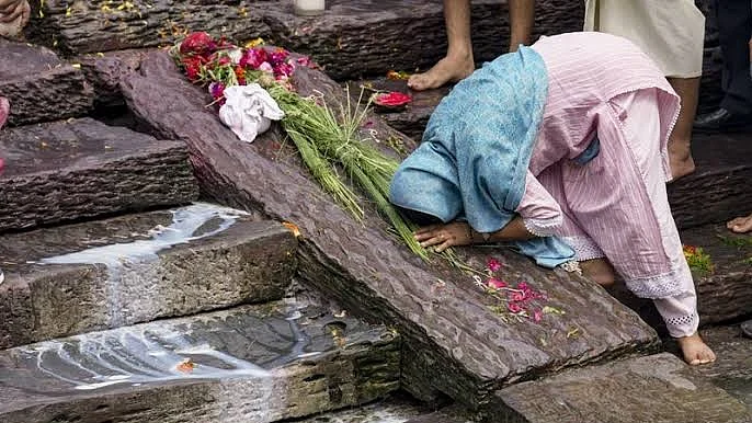 A family member mourns during a symbolic funeral of her loved one. 