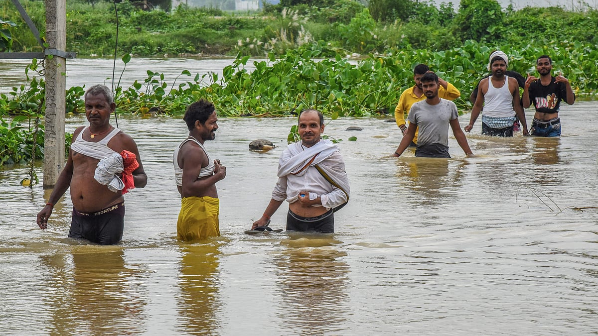 People wade through floodwaters along Patna-Gaya road.