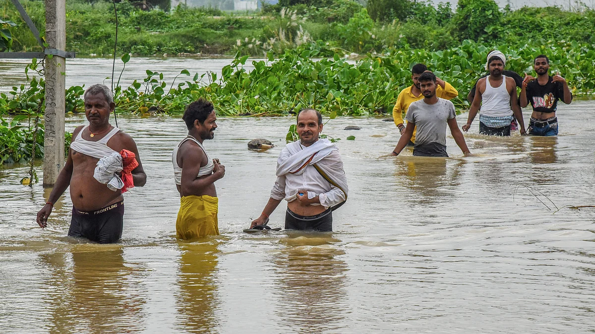 People wade through floodwaters along Patna-Gaya road.