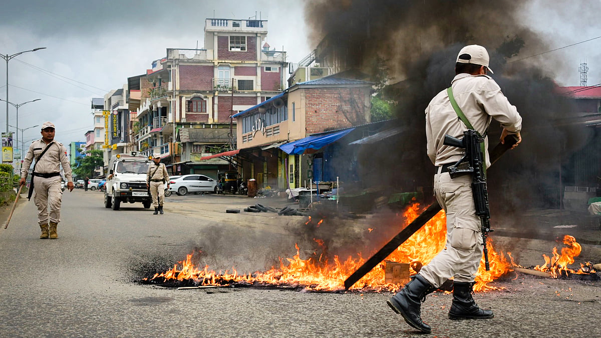 Police douse a fire in the Sagolband area during the 24-hour strike by JFD, in Imphal West, 1 Sept