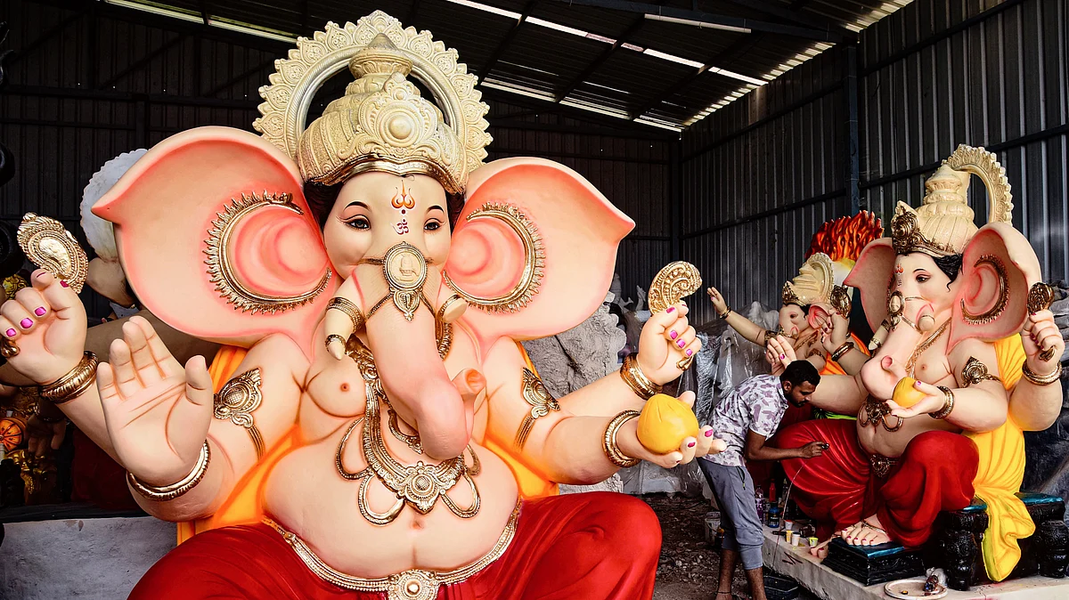 An artist works on an idol of Lord Ganesh ahead of Ganesh Chaturthi, in Satara district, 4 Sept