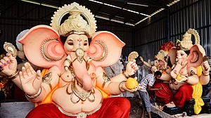 An artist works on an idol of Lord Ganesh ahead of Ganesh Chaturthi, in Satara district, 4 Sept
