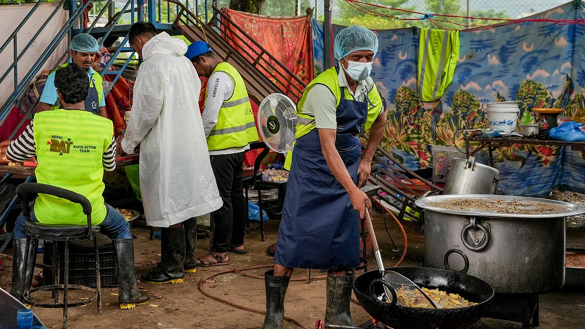 Volunteers and relief workers prepare meals for flood-affected residents in Nuwakot district.