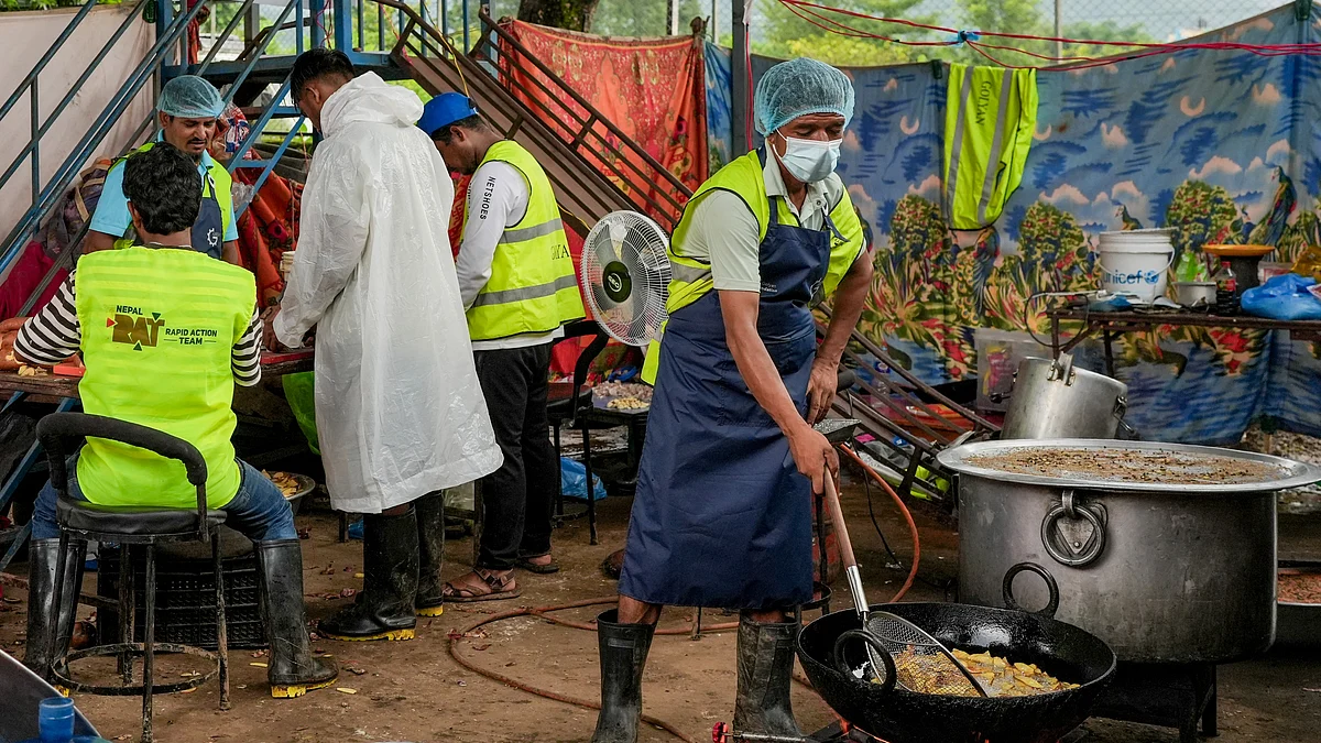 Volunteers and relief workers prepare meals for flood-affected residents in Nuwakot district.