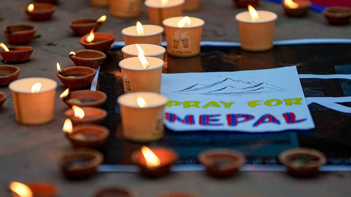 Lamps lit at a vigil for flash flood victims in Kathmandu.