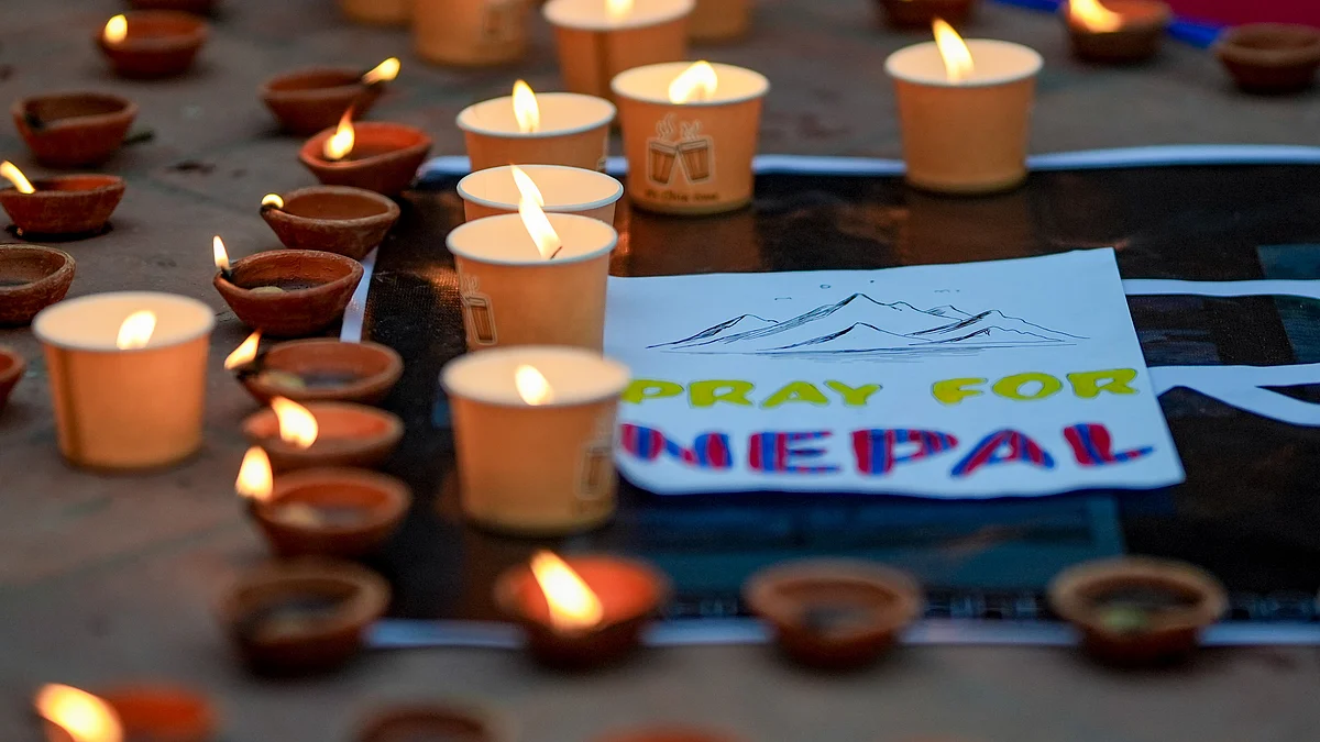 Lamps lit at a vigil for flash flood victims in Kathmandu.