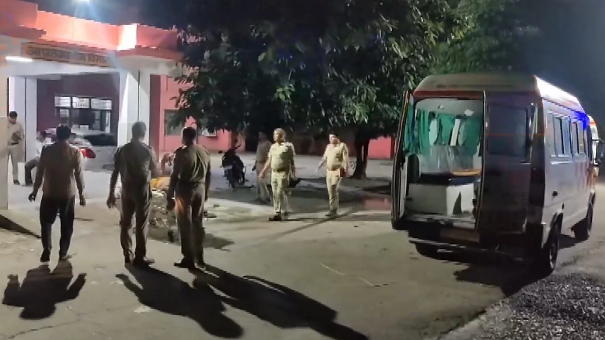 Police personnel near an ambulance after a passenger vehicle overturns in Baghpat.
