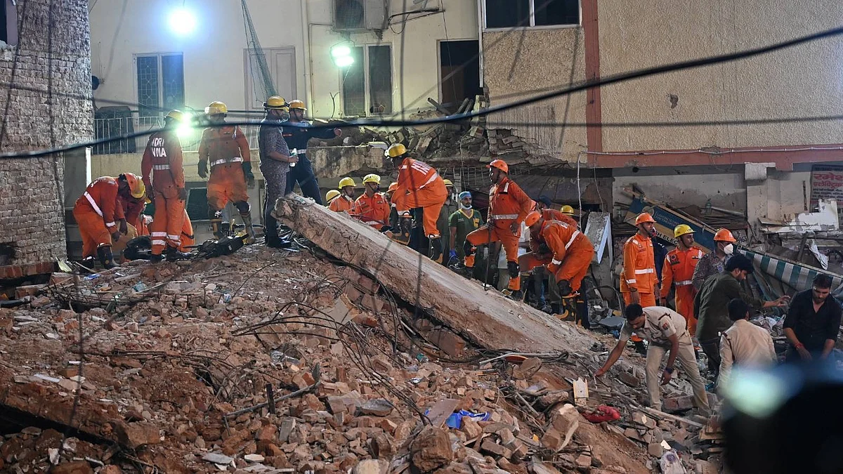 Rescue personnel continue operations in southwest Delhi's Satya Niketan area.