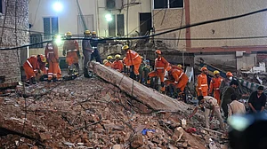 Rescue personnel continue operations in southwest Delhi's Satya Niketan area.