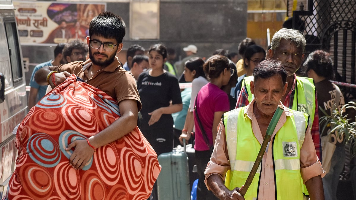 Students carry belongings as they vacate PGs.                                       