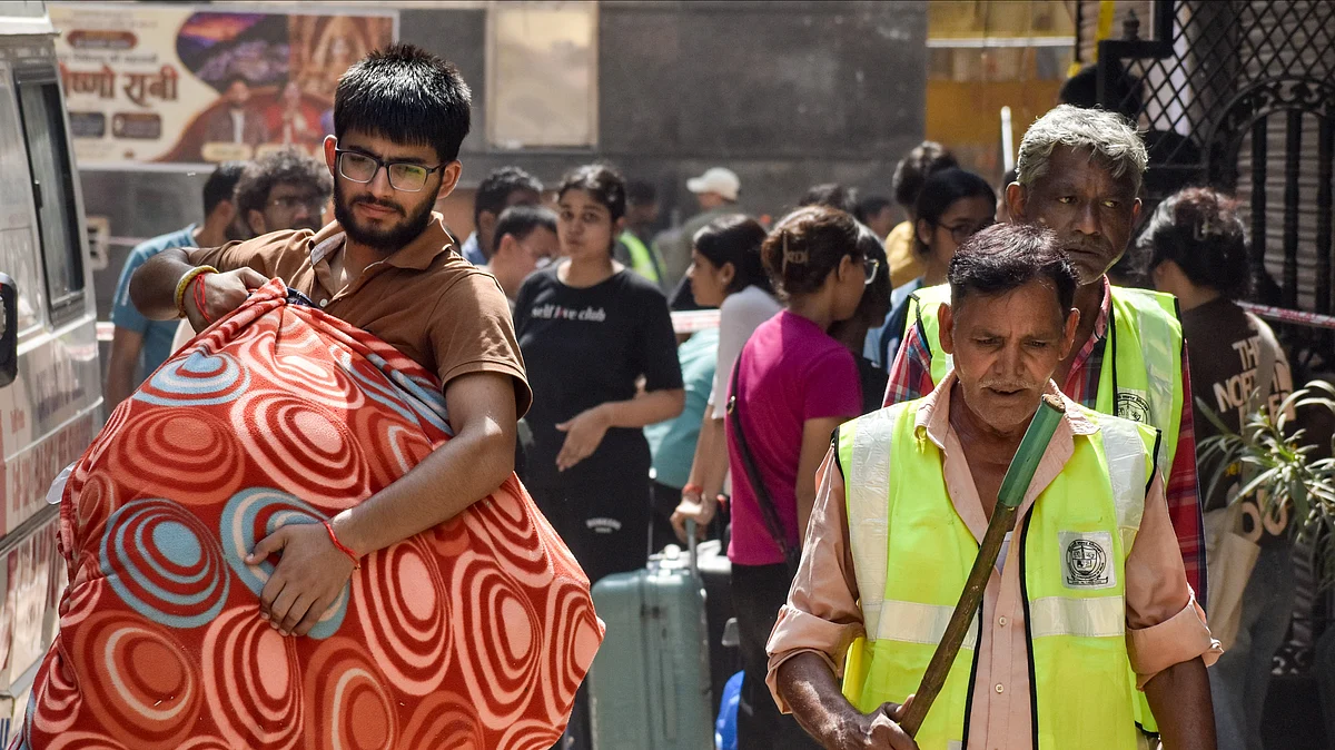 Students carry belongings as they vacate PGs.
