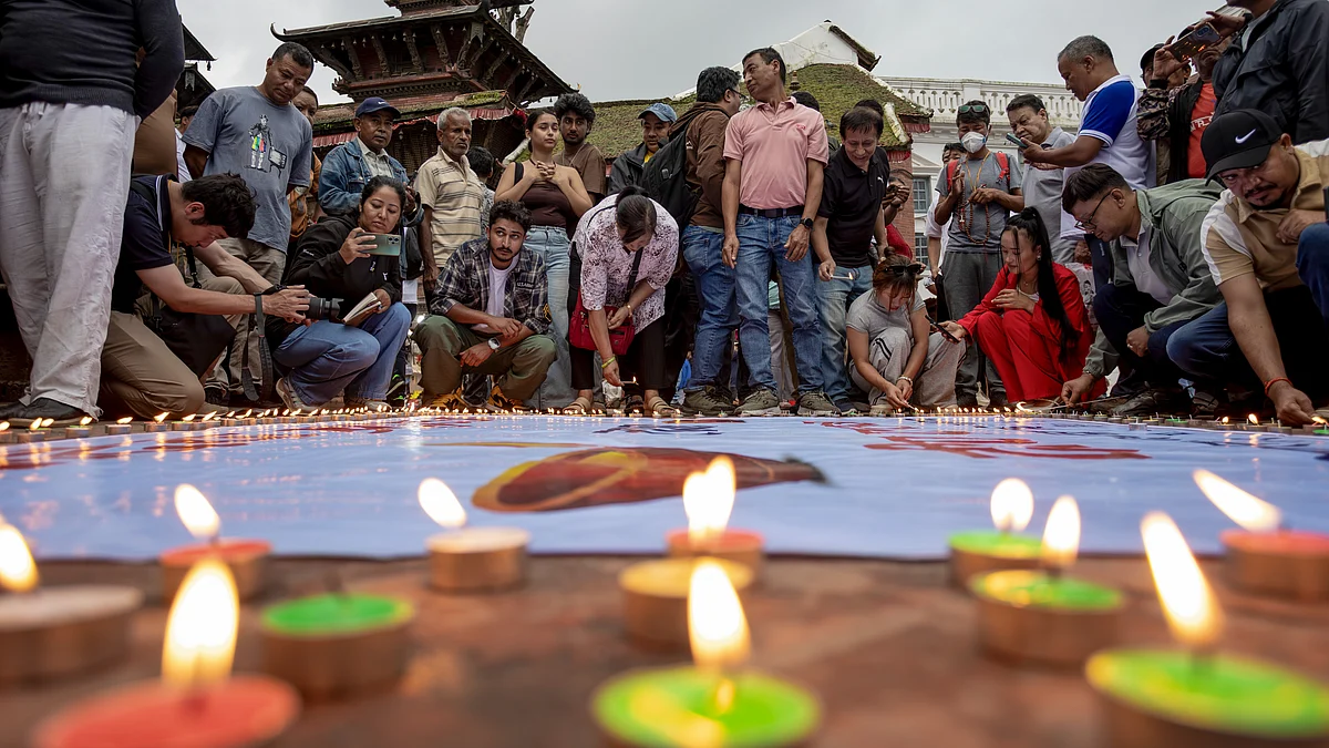 People take part in a candlelight vigil in Kathmandu.