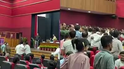 Students shouting slogans, being escorted out