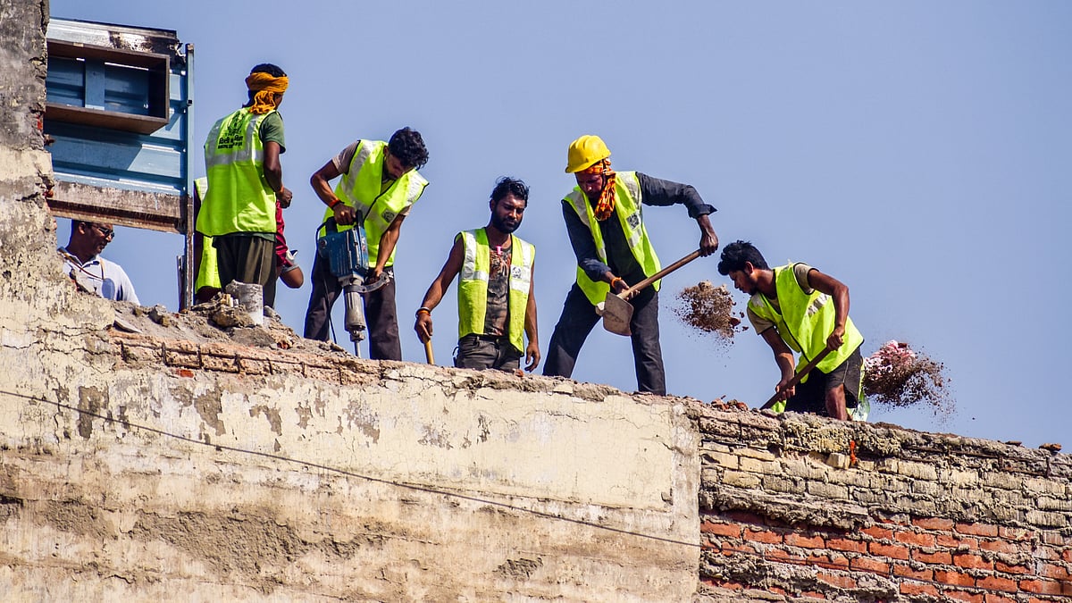 Workers demolish the roof of a building next to the one that collapsed, at Satya Niketan, 10 Sep