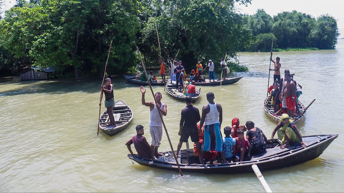 People cross the swollen Kosi river in Purnia.