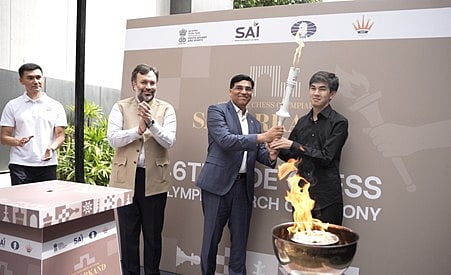 Sindarov (right) with Vishy Anand at the Olympic torch lighting ceremony in India