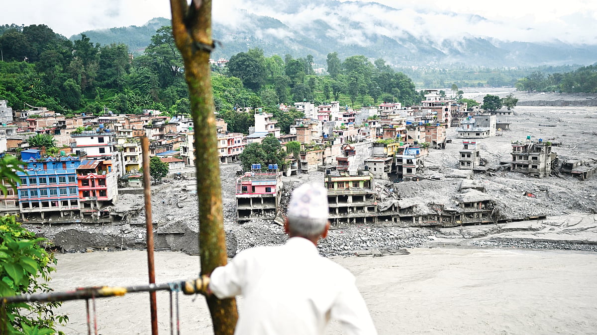 A man takes in the aftermath of floods at Trishuli in Nuwakot district, Nepal