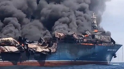An oil tanker engulfed in flames in the Strait of Hormuz.