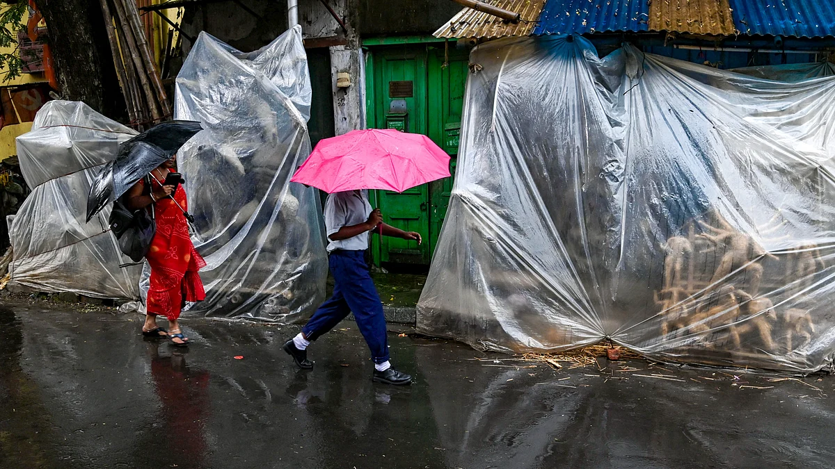Unfinished Durga idols covered in plastic sheets amid rain ahead of Durga Puja in Kolkata.