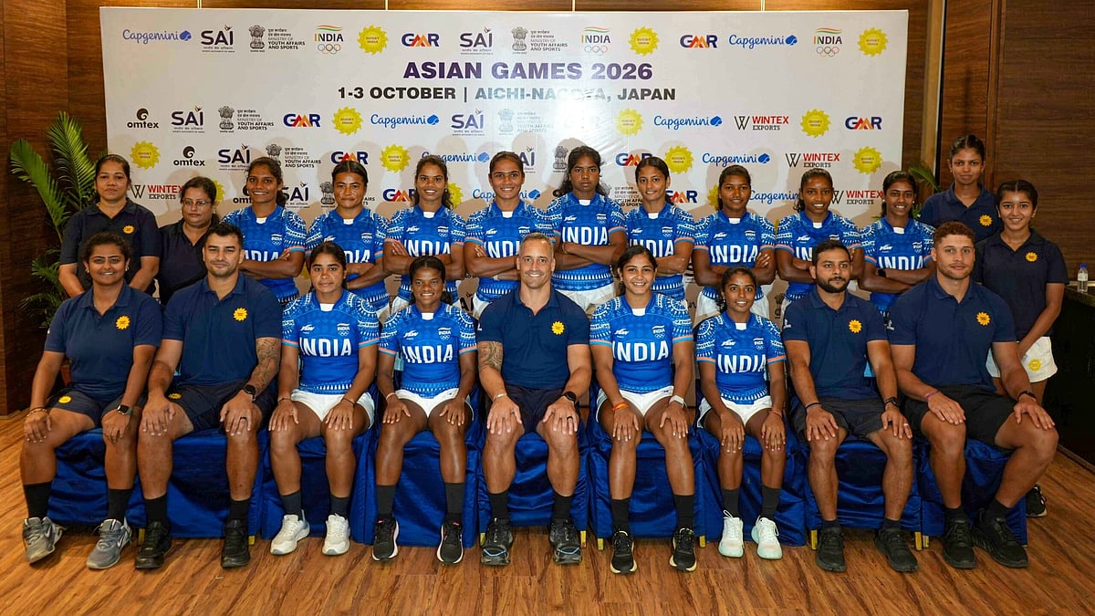 The women's team pose with coach Phil Delport