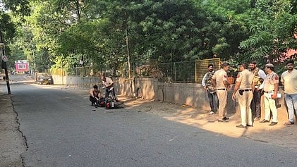 Police personnel investigate outside Aastha Kunj Park.