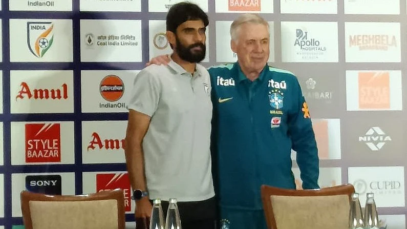 Battle of the inequals: Carlo Ancelotti (right) and Khalid Jamil.